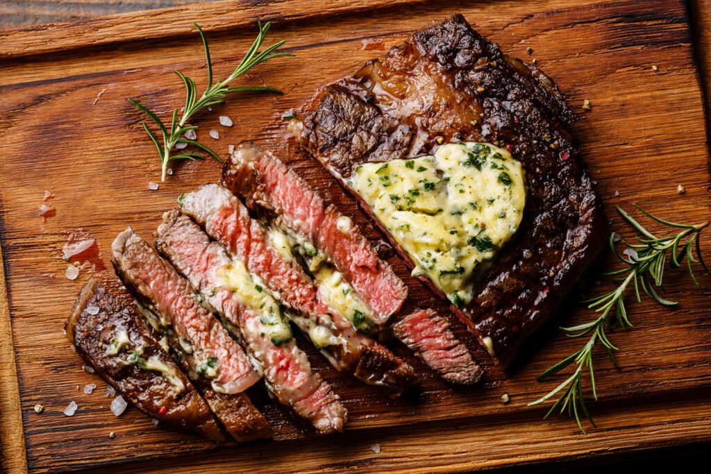 Delicious Porterhouse Steak sliced with Garlic Butter and Rosemary | The Aviator Event Venue in Cleveland