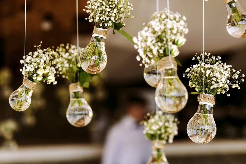 wedding decoration in the form of mini-vases and bouquets of flowers hanging